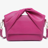 Pink handbag with a bow design close-up