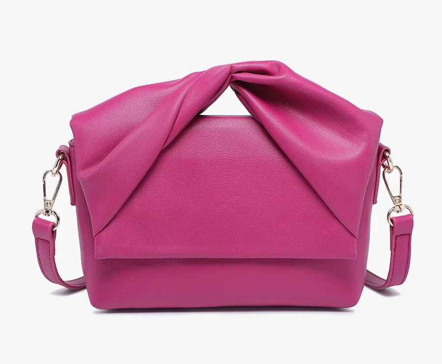 Pink handbag with a bow design close-up