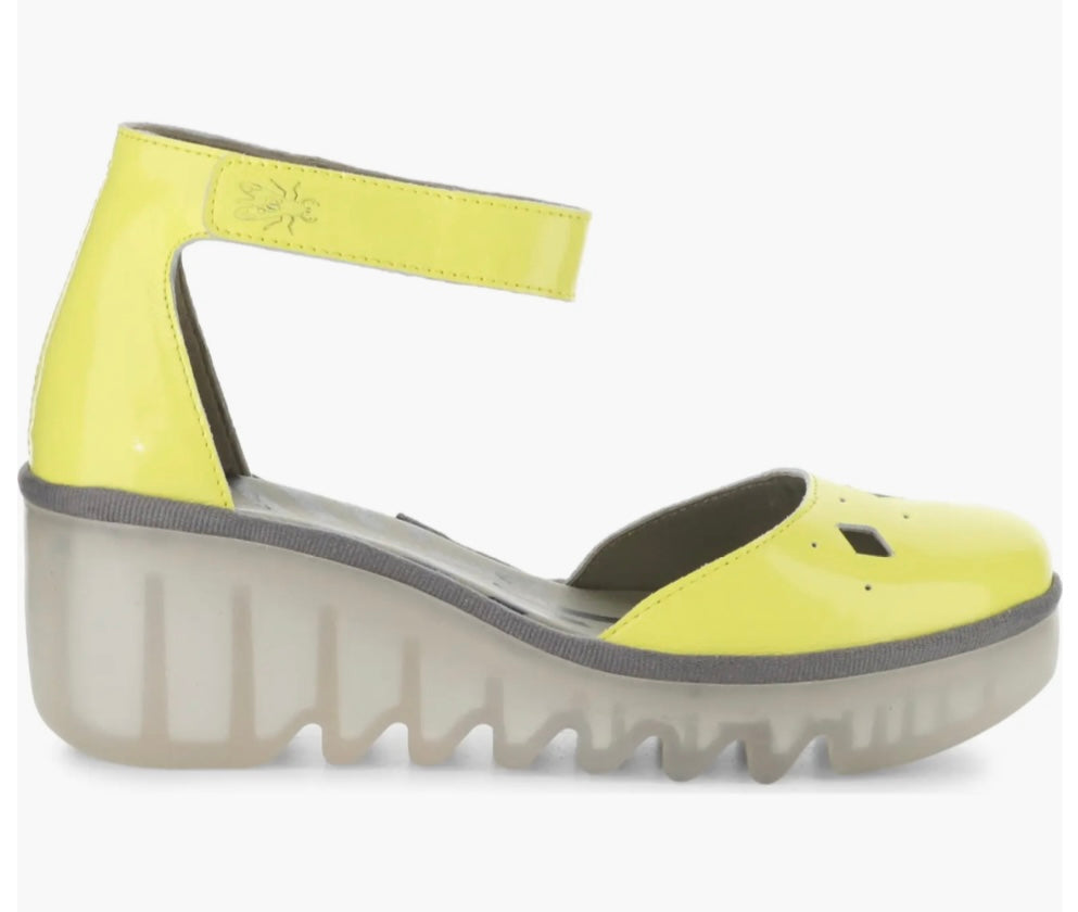 Yellow wedge with clear sole and velcro strap close-up