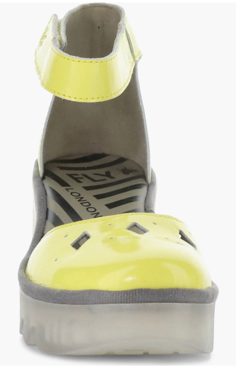 Yellow wedge with clear sole and velcro strap front view