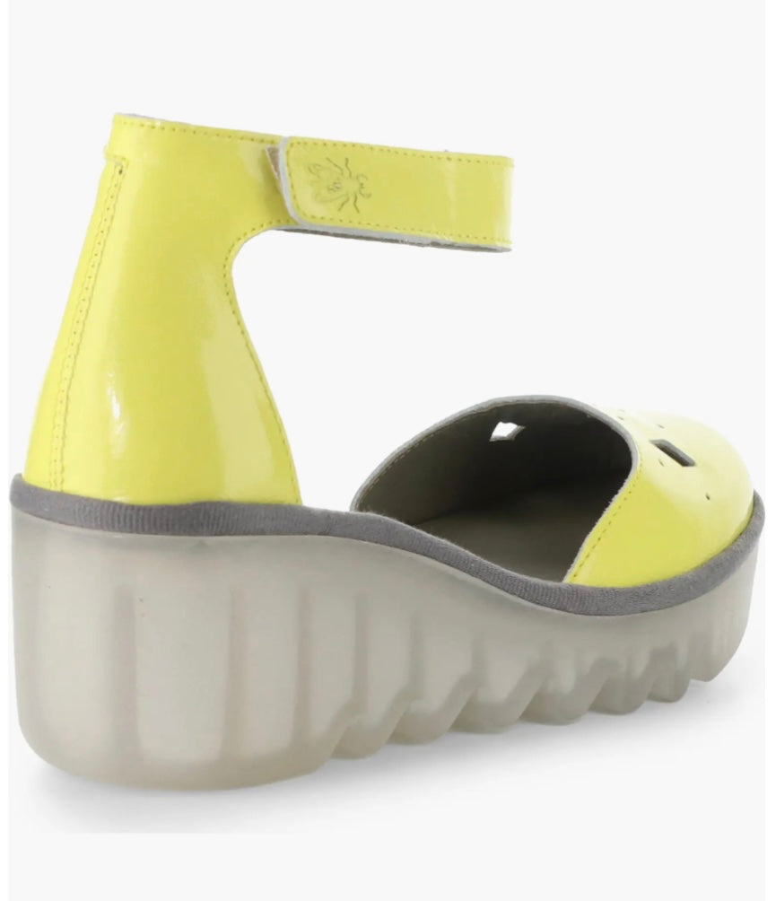 Yellow wedge with clear sole and velcro strap rear view