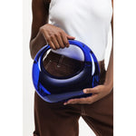 Transparent blue circular acrylic handbag with a gold chain strap model