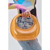 Transparent orange circular acrylic handbag with a gold chain strap model