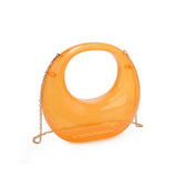 Transparent orange circular acrylic handbag with a gold chain strap alt view