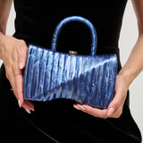 Blue marbled handbag with gold gold shoulder chain strap and blue handles model