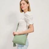 Green textured handbag with a green black and white striped strap model 