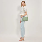Green textured handbag with a green black and white striped strap model 3