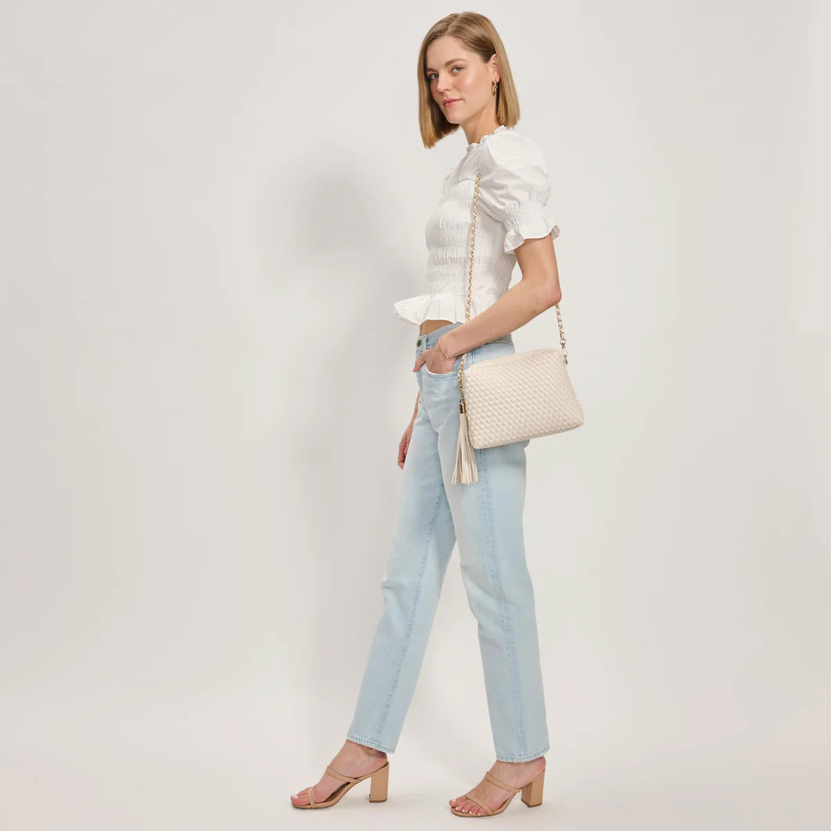 White textured handbag with a black and white striped strap model 2