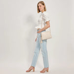White textured handbag with a black and white striped strap model 2