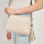 White textured handbag with a black and white striped strap model 4