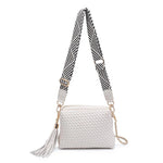 White textured handbag with a black and white striped strap