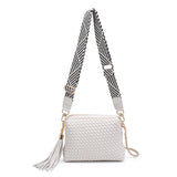 White textured handbag with a black and white striped strap