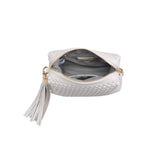 White textured handbag with a black and white striped strap opening