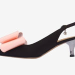 Black high-heeled shoe with pink bow side view