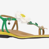Green sandal with a white flower and yellow heel front view