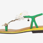 Green sandal with a white flower and yellow heel side view
