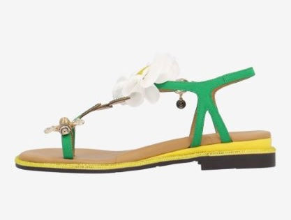 Green sandal with a white flower and yellow heel side view