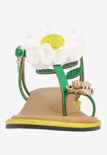Green sandal with a white flower and yellow heel toe box