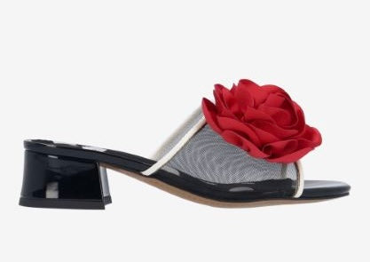 Black heel with a red flower and white/transparent strap close-up