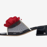 Black heel with a red flower and white/transparent strap inside view
