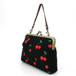 Black handbag with red cherry design side view