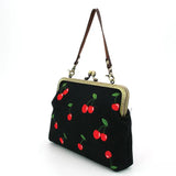 Black handbag with red cherry design side view