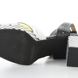 High-heeled platform shoe with checkered heel and yellow/white toe strap sole