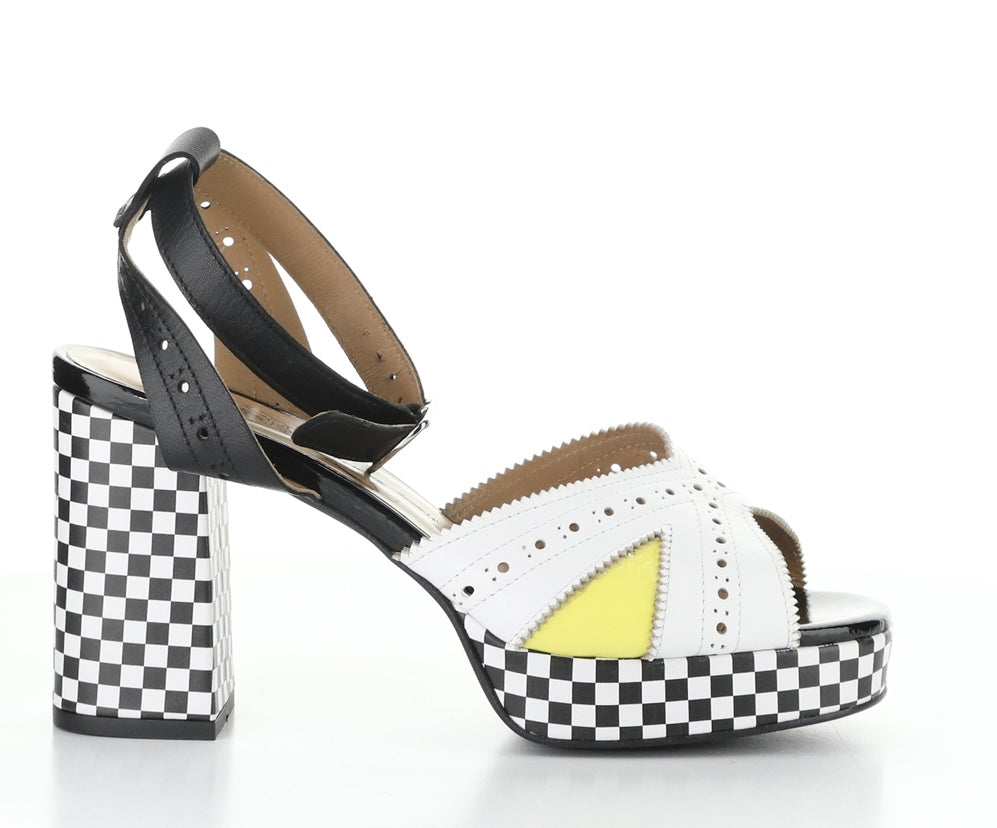 High-heeled platform shoe with checkered heel and yellow/white toe strap close-up