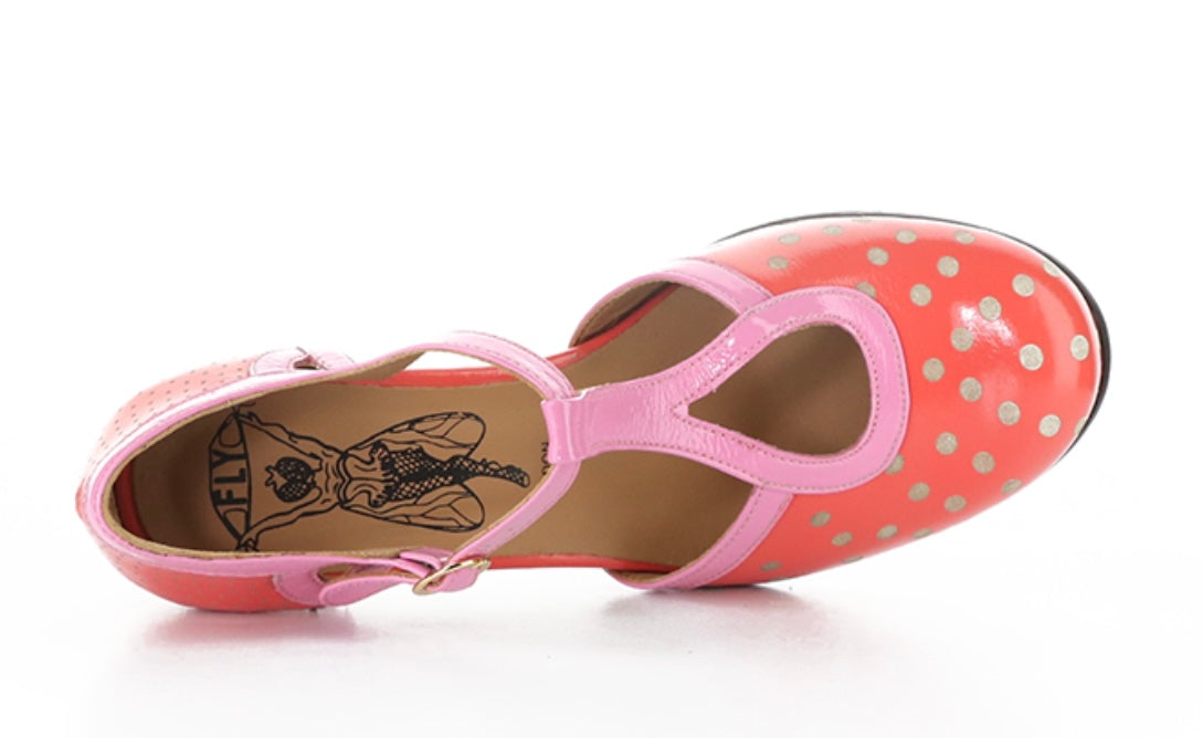 Red polka dot shoe with pink strap and buckle closure top view