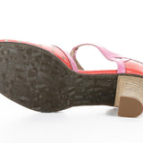 Red polka dot shoe with pink strap and buckle closure sole