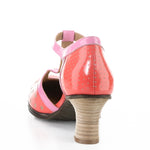 Red polka dot shoe with pink strap and buckle closure heel view