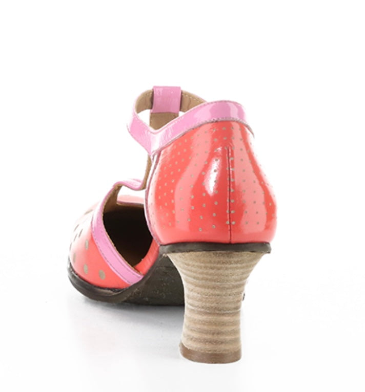 Red polka dot shoe with pink strap and buckle closure heel view