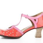 Red polka dot shoe with pink strap and buckle closure inside view