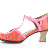 Red polka dot shoe with pink strap and buckle closure inside view
