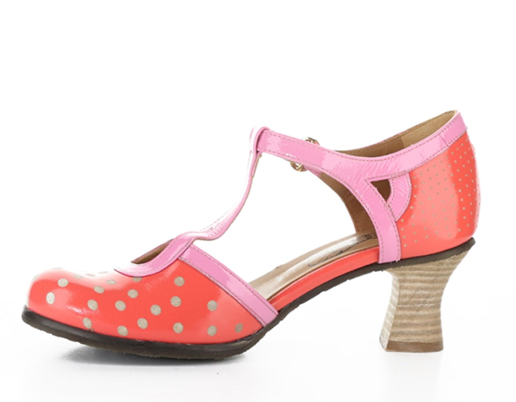 Red polka dot shoe with pink strap and buckle closure inside view