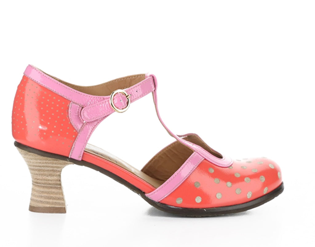 Red polka dot shoe with pink strap and buckle closure close-up