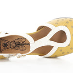 Yellow polka-dot shoe with white straps and buckle closure top view