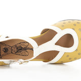 Yellow polka-dot shoe with white straps and buckle closure top view