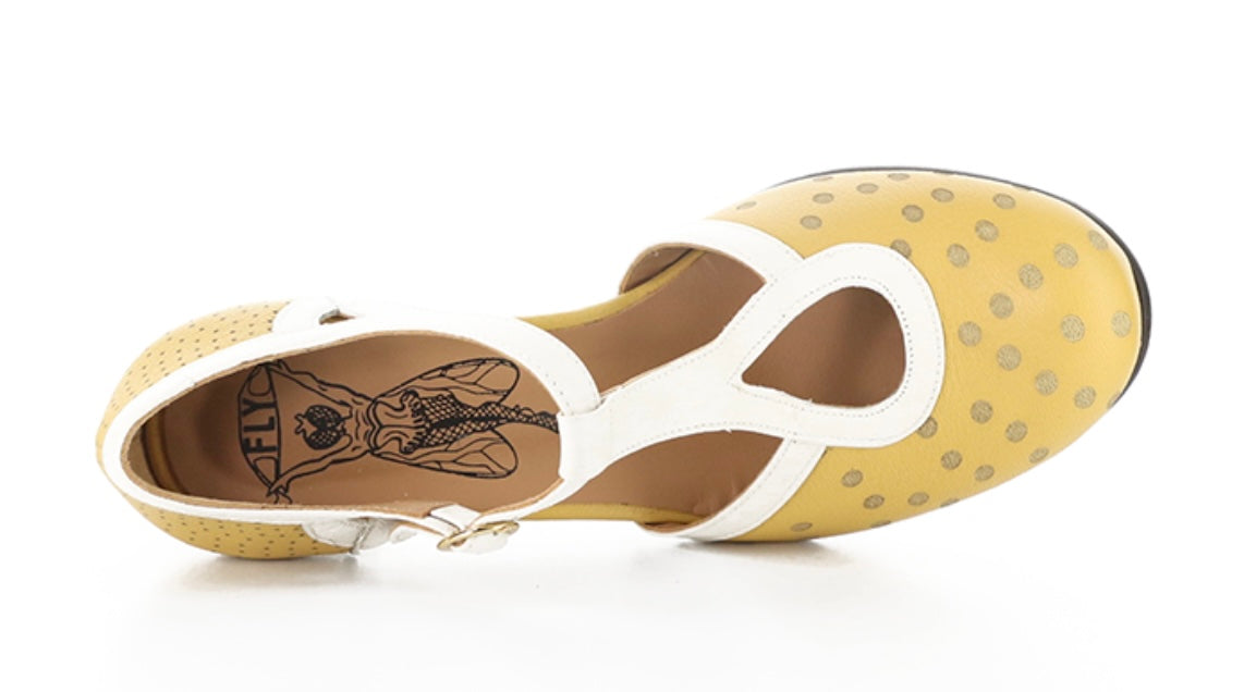 Yellow polka-dot shoe with white straps and buckle closure top view