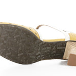 Yellow polka-dot shoe with white straps and buckle closure sole