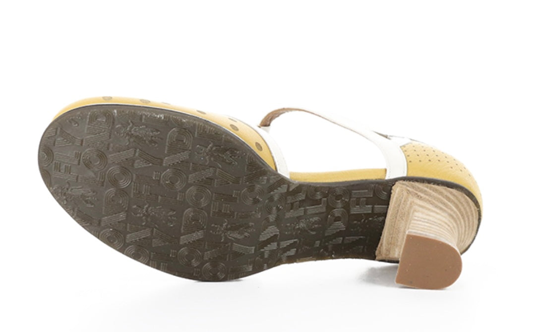 Yellow polka-dot shoe with white straps and buckle closure sole