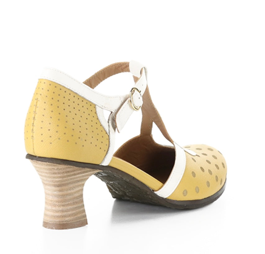 Yellow polka-dot shoe with white straps and buckle closure heel view