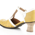 Yellow polka-dot shoe with white straps and buckle closure inside view