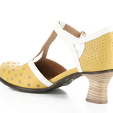 Yellow polka-dot shoe with white straps and buckle closure inside view