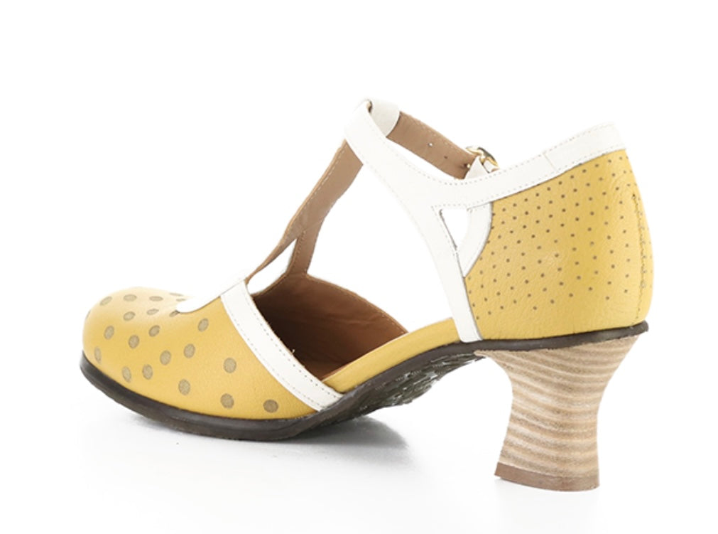 Yellow polka-dot shoe with white straps and buckle closure inside view