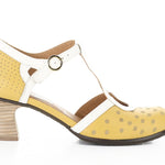 Yellow polka-dot shoe with white straps and buckle closure close-up