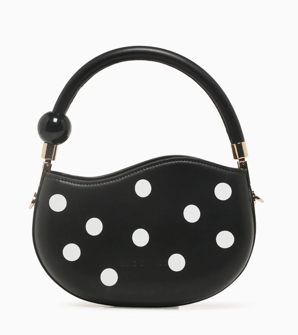 Black round handbag with white polka dots