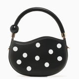 Black round handbag with white polka dots