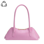 Pink handbag with a gold zipper and pink hand strap close-up