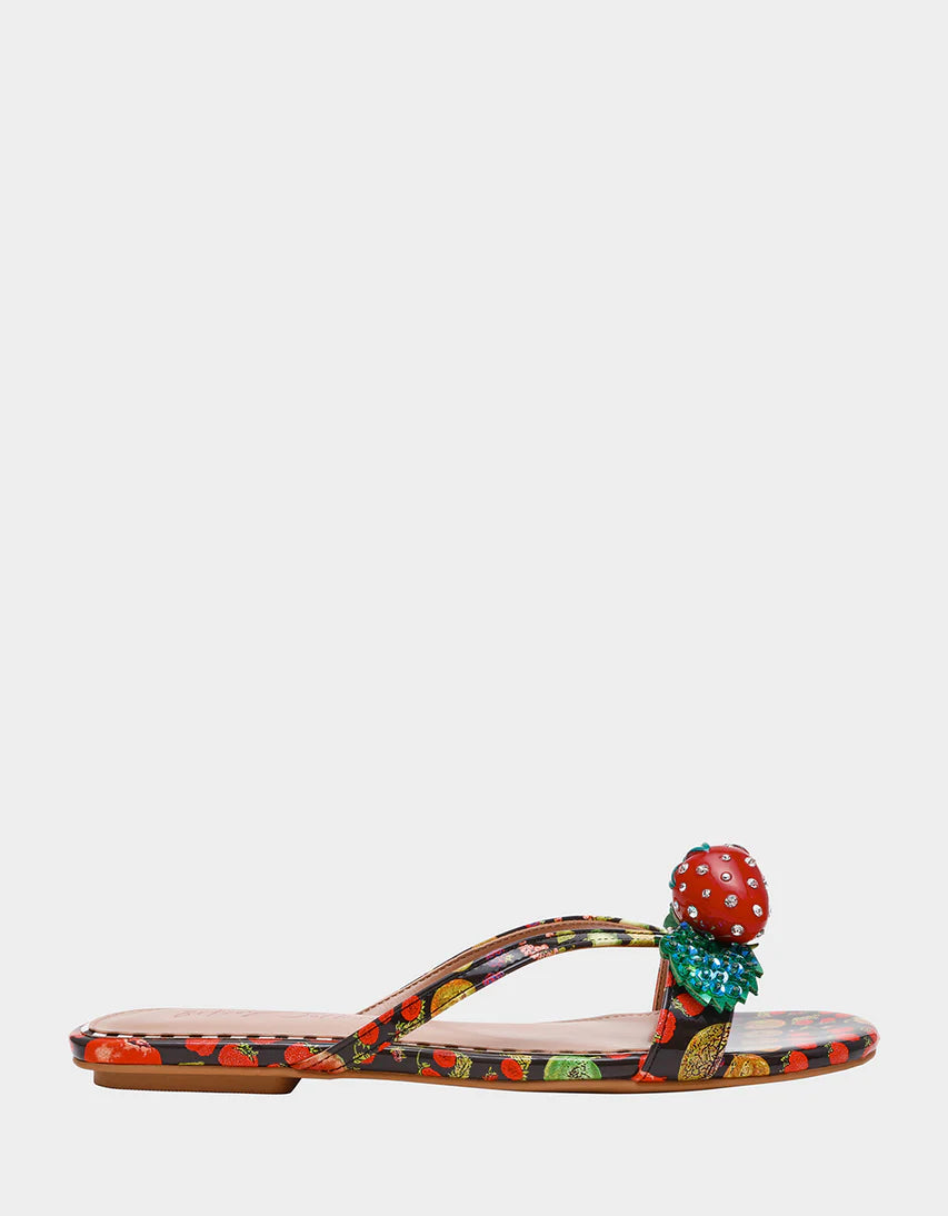 Colorful sandal with a decorative strawberry on toe strap close-up